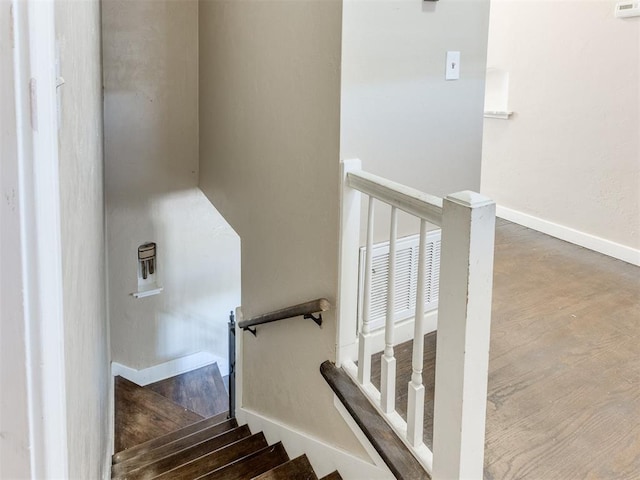 staircase featuring hardwood / wood-style flooring