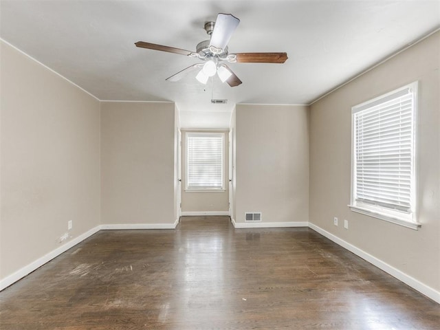 empty room with ceiling fan and dark wood-type flooring