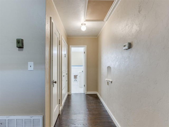 hallway featuring dark hardwood / wood-style floors and crown molding