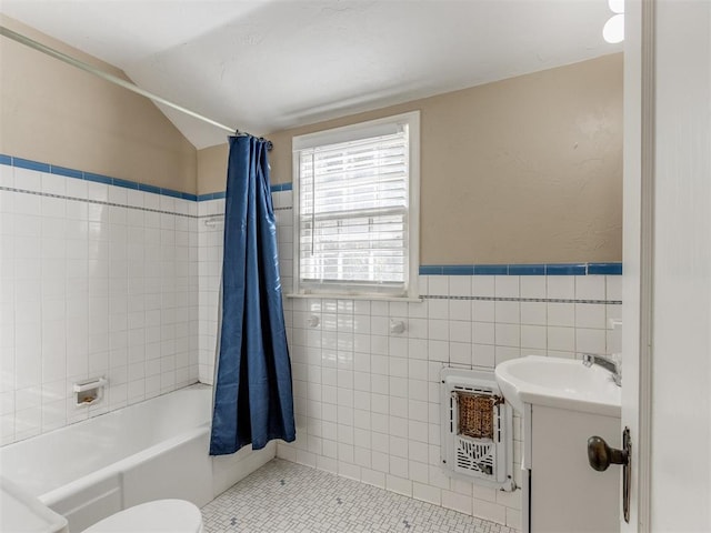 full bathroom featuring vanity, tile patterned flooring, shower / bathtub combination with curtain, tile walls, and heating unit