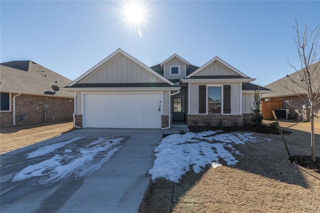 craftsman-style home featuring a garage and central AC