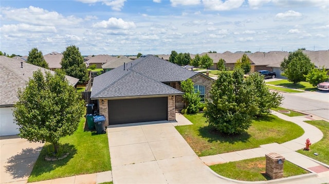 view of front of home with a garage and a front lawn