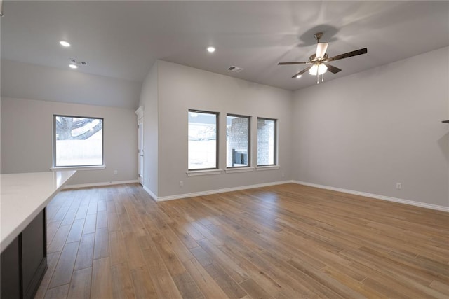 unfurnished living room featuring light hardwood / wood-style floors and ceiling fan