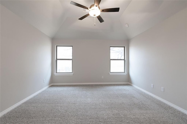 unfurnished room with carpet floors, ceiling fan, plenty of natural light, and vaulted ceiling