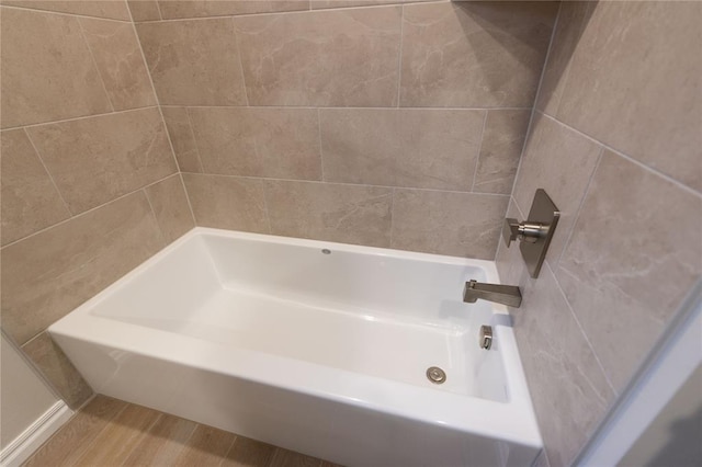 bathroom with wood-type flooring and shower / bath combination