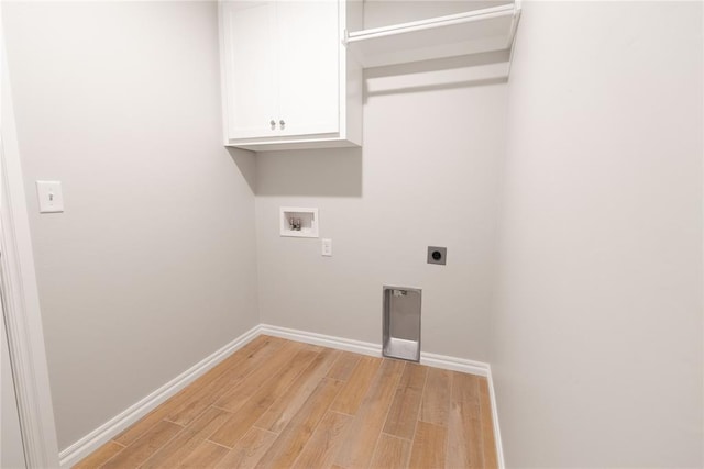 laundry room featuring electric dryer hookup, washer hookup, cabinets, and light wood-type flooring