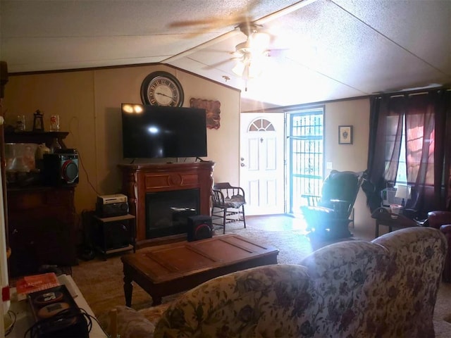 carpeted living room featuring ceiling fan, lofted ceiling, and a textured ceiling