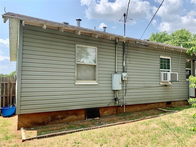 view of property exterior featuring a lawn and cooling unit