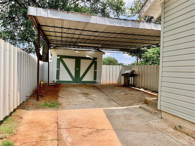 view of patio / terrace with a carport and a grill