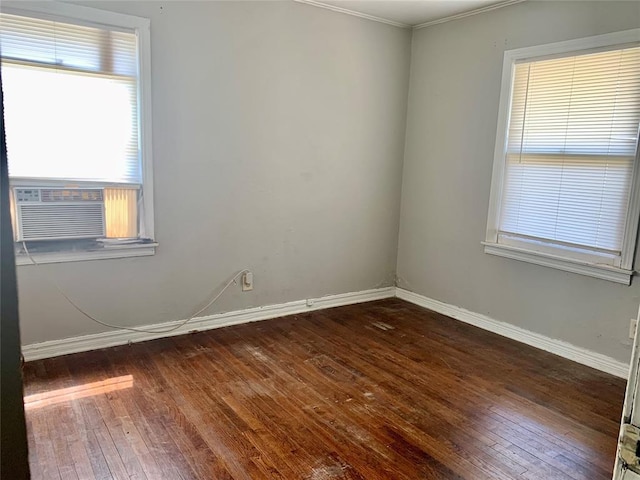 empty room with dark hardwood / wood-style flooring, cooling unit, and ornamental molding