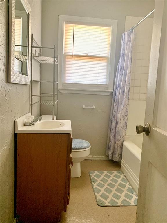 full bathroom featuring vanity, shower / tub combo, and toilet