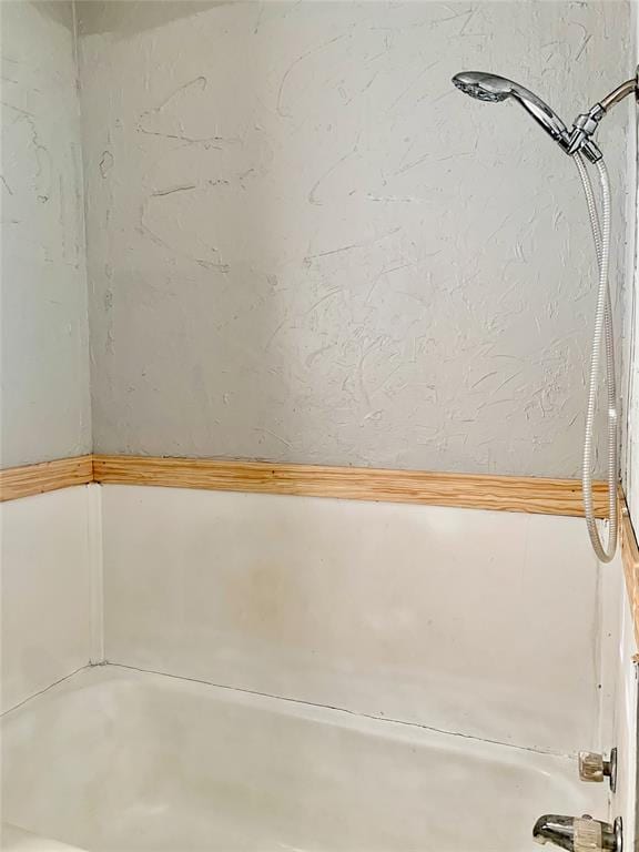 bathroom with washtub / shower combination