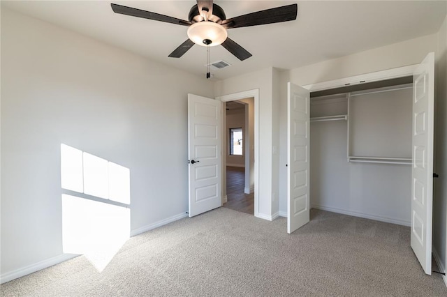 unfurnished bedroom featuring a closet, ceiling fan, and light carpet