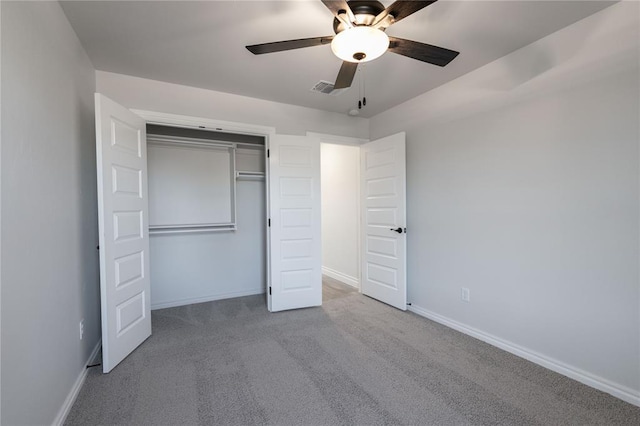 unfurnished bedroom featuring ceiling fan, a closet, and light carpet