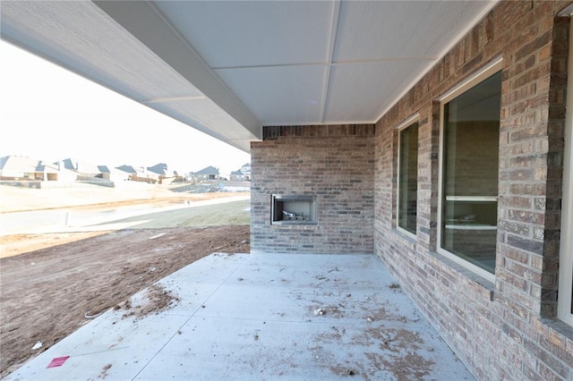 view of patio with an outdoor brick fireplace