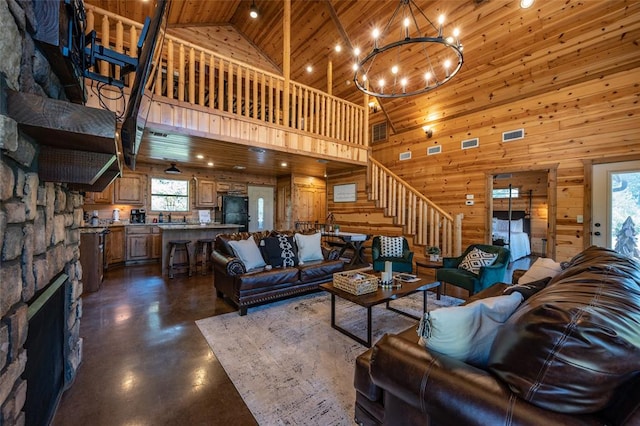 living room featuring a fireplace, wooden walls, high vaulted ceiling, wooden ceiling, and a chandelier