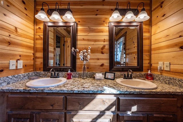 bathroom featuring vanity and wood walls