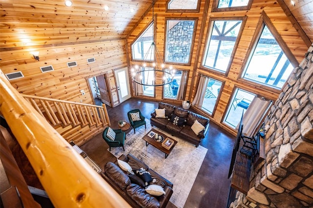 living room with wood walls, high vaulted ceiling, wood ceiling, and an inviting chandelier