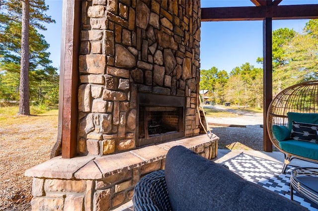 view of patio featuring an outdoor stone fireplace