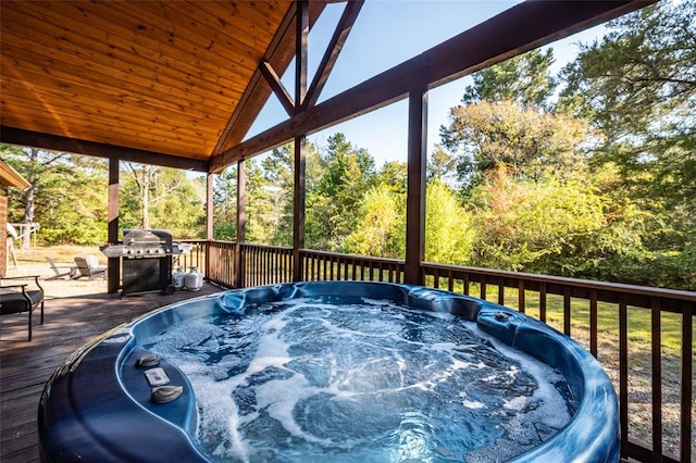 wooden deck with grilling area and a hot tub