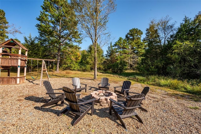 view of yard with a playground and an outdoor fire pit