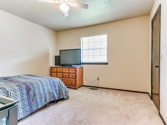 bedroom featuring ceiling fan, a closet, and light carpet