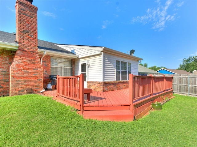 wooden deck featuring a lawn