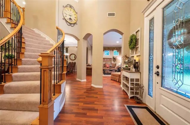 entryway featuring dark hardwood / wood-style flooring, a high ceiling, and plenty of natural light