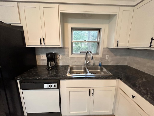 kitchen with white dishwasher, decorative backsplash, white cabinetry, and sink