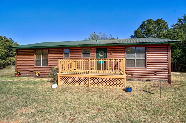 rear view of property with a lawn