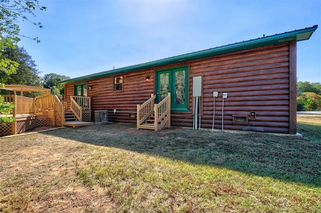 back of house with a lawn and central AC