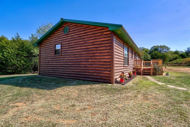 view of side of property with a lawn and a deck