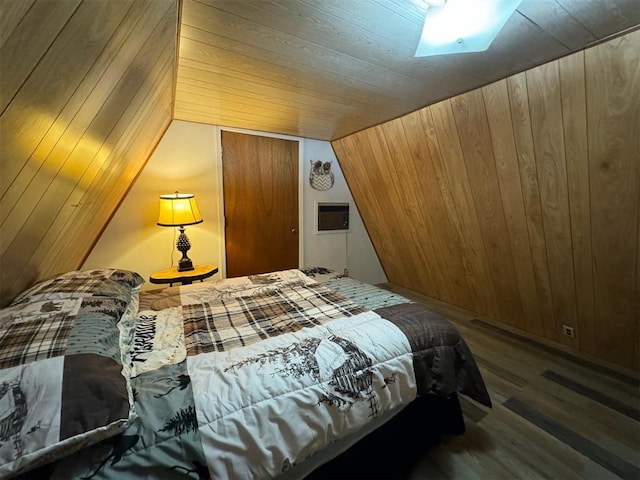 bedroom featuring wood-type flooring, vaulted ceiling, and wooden walls