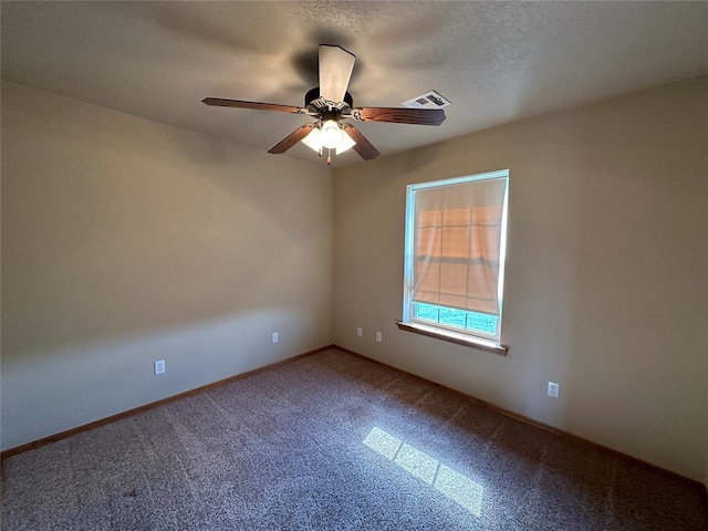 spare room featuring ceiling fan and a textured ceiling