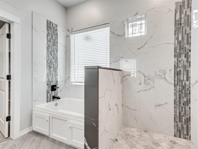 bathroom featuring independent shower and bath