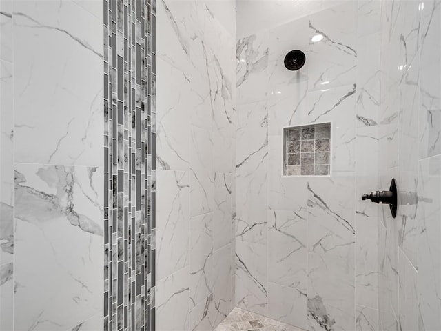 bathroom with a tile shower