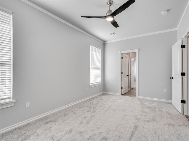 unfurnished bedroom with ornamental molding, light carpet, ceiling fan, and ensuite bath