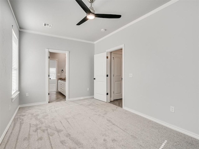 unfurnished bedroom with crown molding, connected bathroom, light colored carpet, and ceiling fan