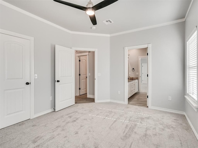 unfurnished bedroom with crown molding, light colored carpet, and multiple windows