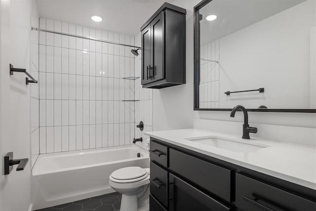 full bathroom featuring tile patterned flooring, toilet, vanity, and tiled shower / bath