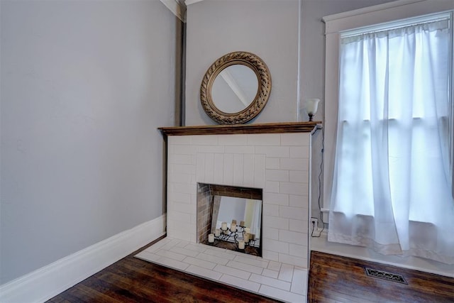 details with a fireplace and wood-type flooring