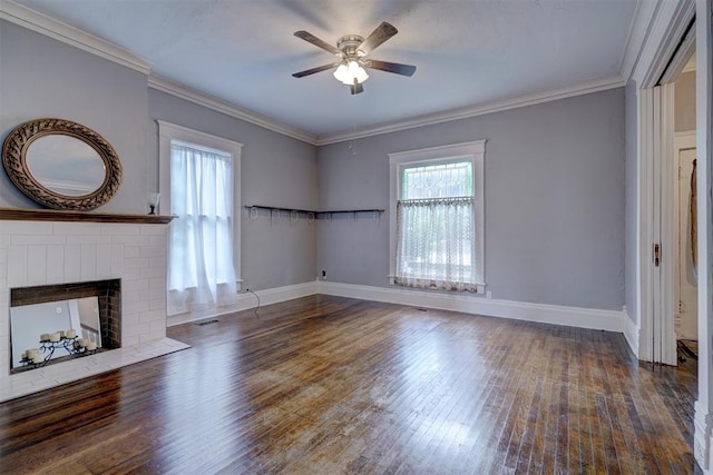 unfurnished living room featuring a fireplace, dark hardwood / wood-style floors, ceiling fan, and crown molding