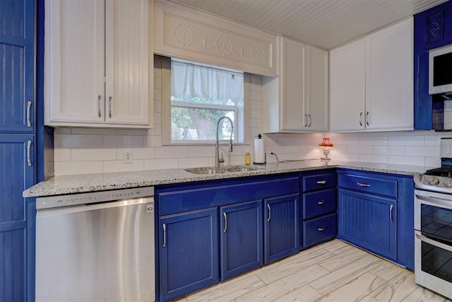 kitchen featuring blue cabinetry, light stone countertops, sink, stainless steel appliances, and white cabinets