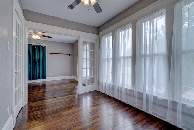 unfurnished room featuring ceiling fan, dark hardwood / wood-style flooring, and french doors