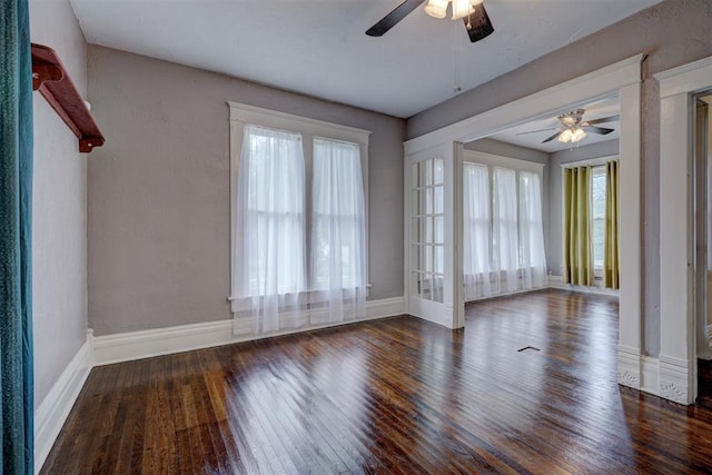 unfurnished room featuring ceiling fan and dark wood-type flooring