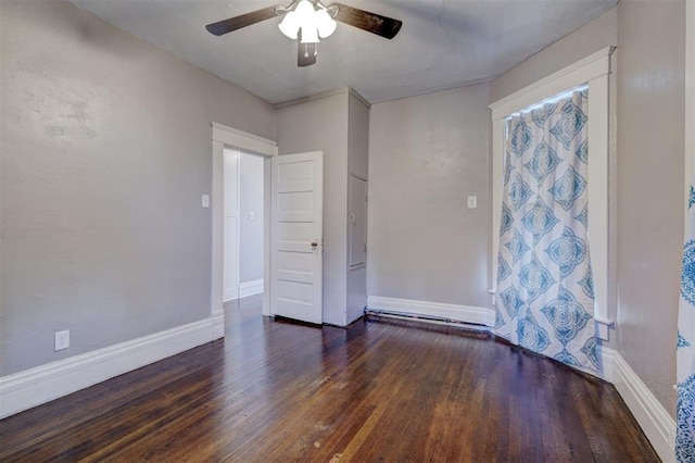 unfurnished room with dark hardwood / wood-style floors and ceiling fan