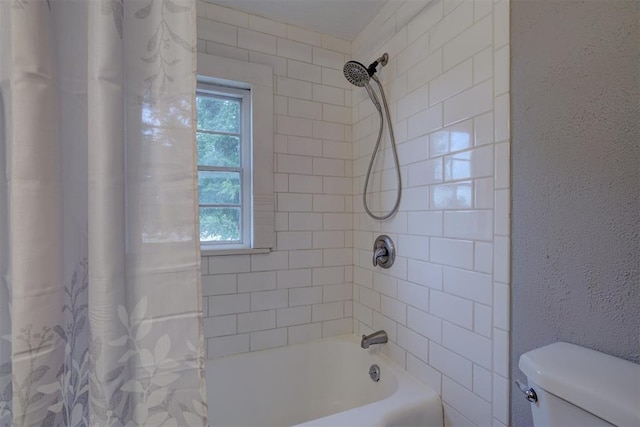 bathroom with shower / bathtub combination with curtain and toilet