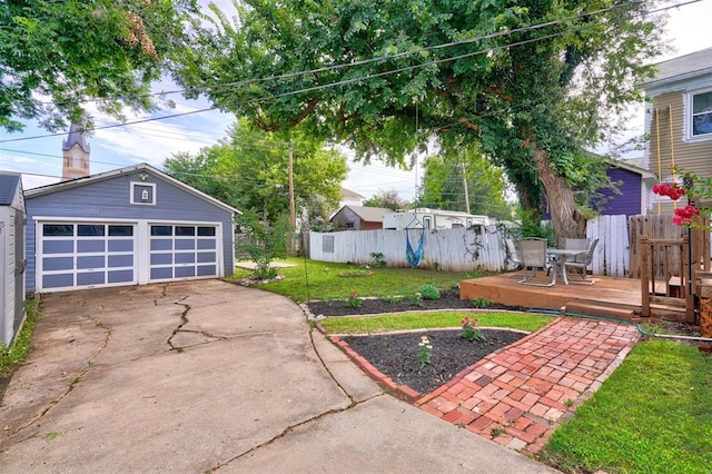 view of yard with a wooden deck, an outdoor structure, and a garage