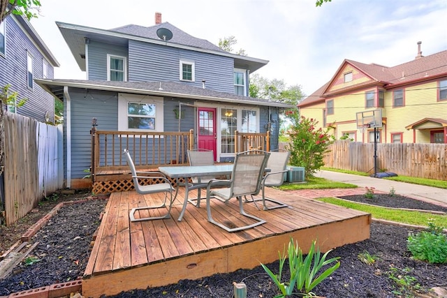 rear view of house with central AC unit and a deck