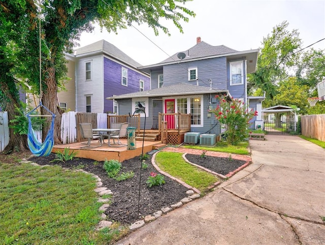 back of property featuring central AC unit and a patio